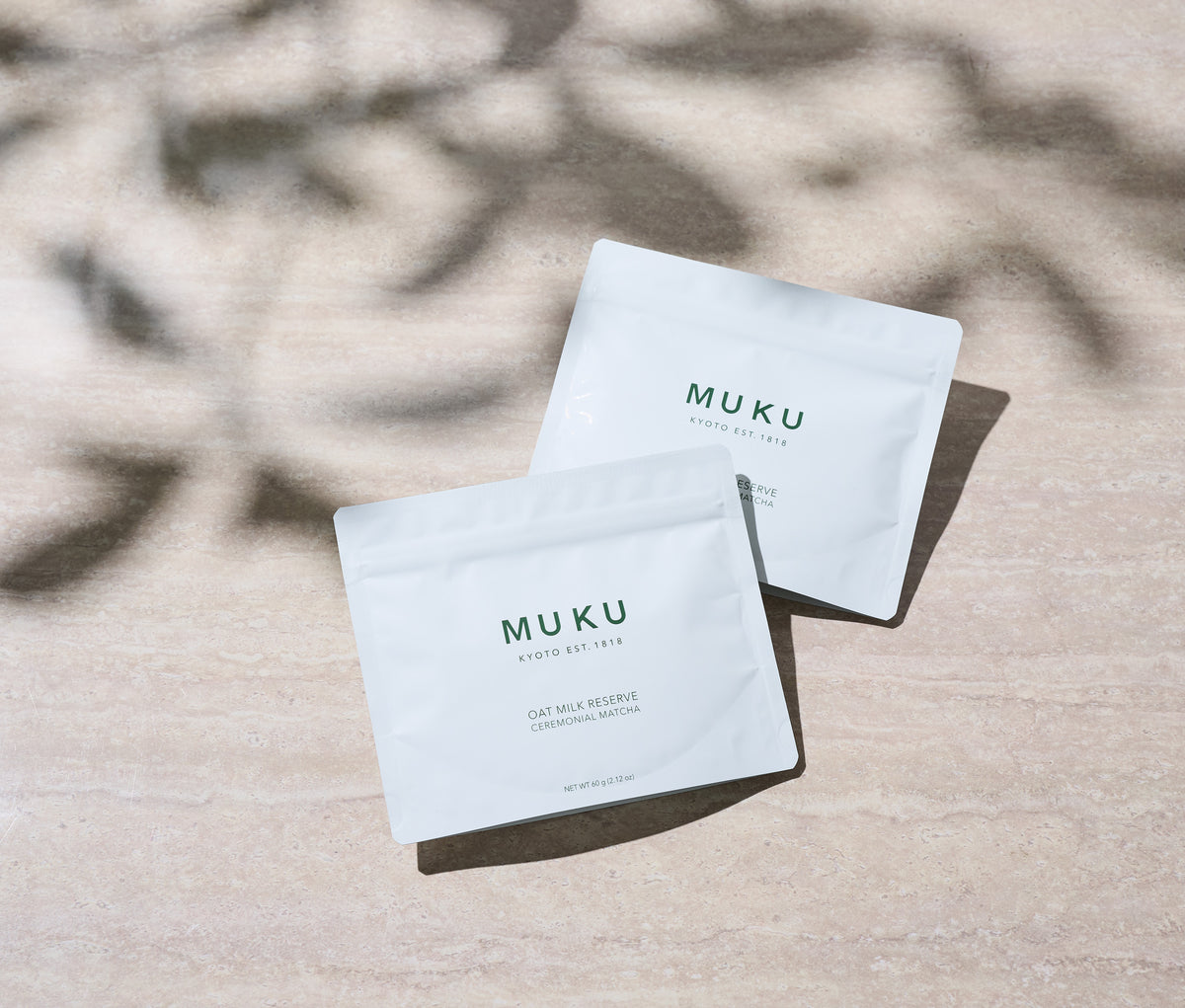 Two MUKU Oat Milk Reserve pouches in morning light