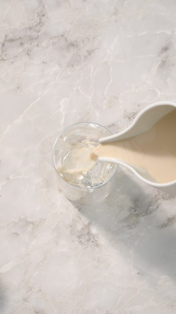A glass with ice and oat milk