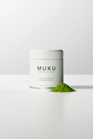 MUKU Oat Milk Reserve 30g tin, front view with matcha powder
